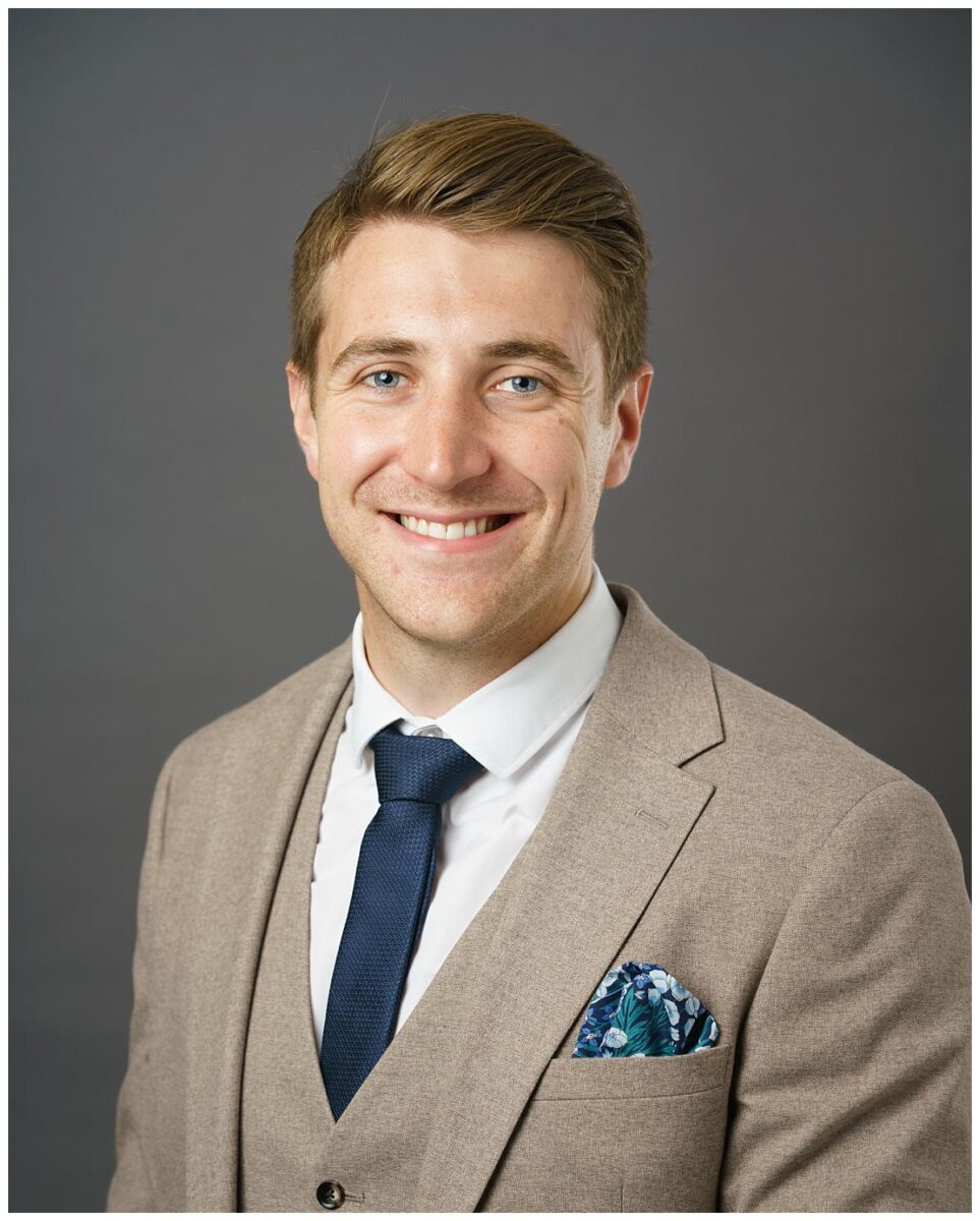 rofessional headshot photograph taken by Northern Ireland's top headshot photographer in Belfast of a man in a suit on a grey backdrop